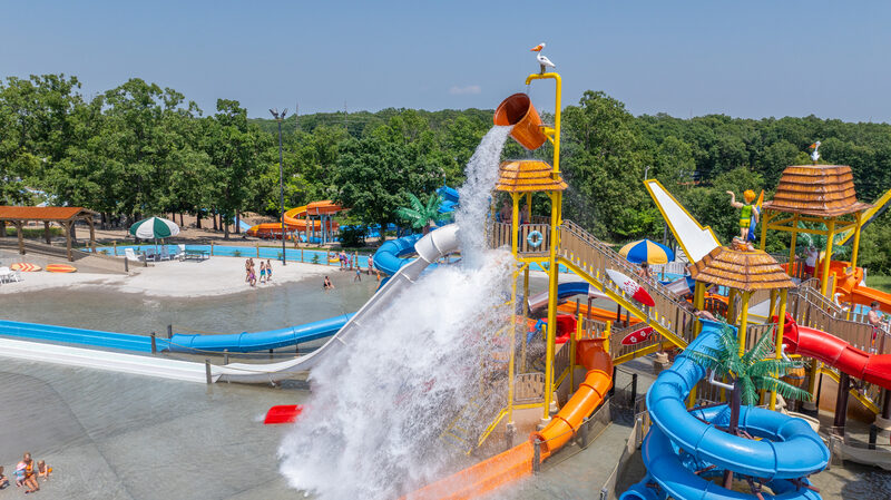 Adventure Island giant tipping bucket dumping water over kids on tube slides